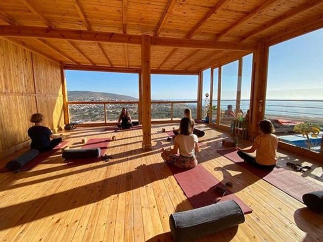group of people enjoying yoga in a sunny day on amouage hotel terrace in taghazout morocco