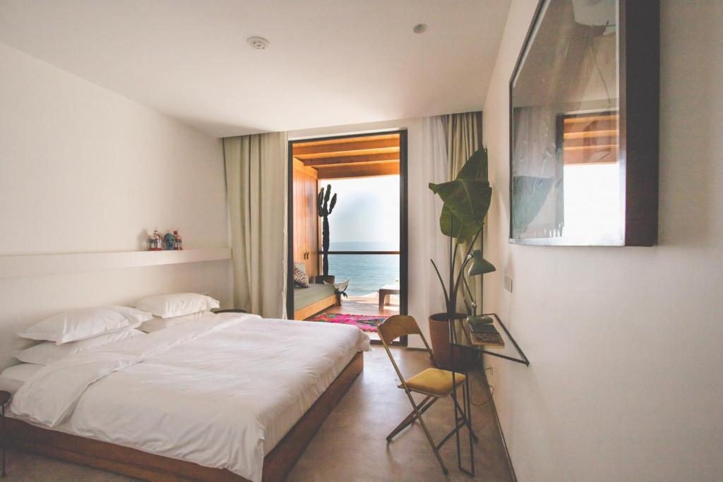 a bedroom with balcony in amouage hotel in taghazout witch ocean view
