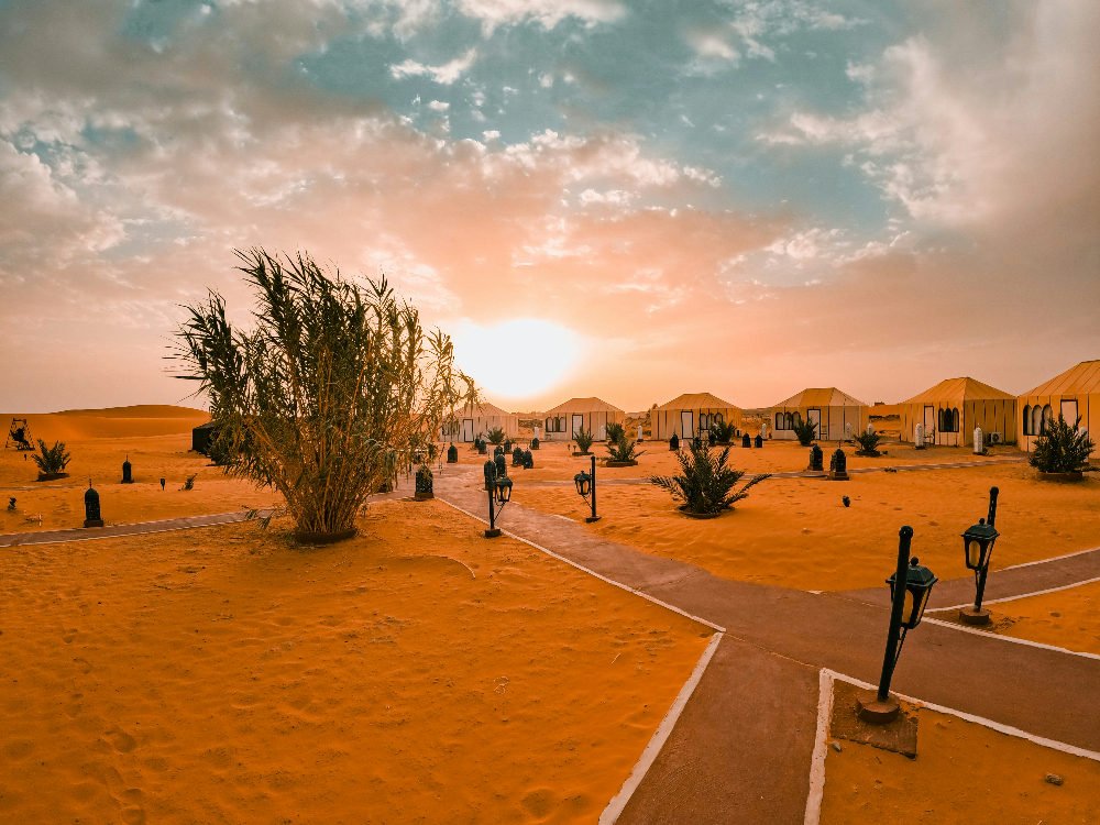 sand dunes next to tents in a sahara camp in erg chebbi morocco